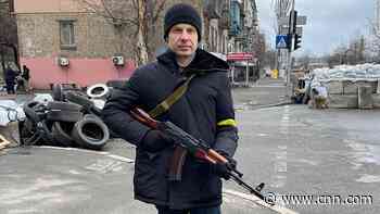 With roadblocks, rifles and Ukrainian flags, Kyiv residents brace for arrival of huge Russian convoy