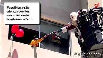 Papai Noel usa escada dos bombeiros para levar presentes a crianças com Covid no Peru - Globo.com
