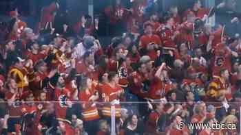 Many unmasked hockey fans jam into Saddledome as restrictions drop