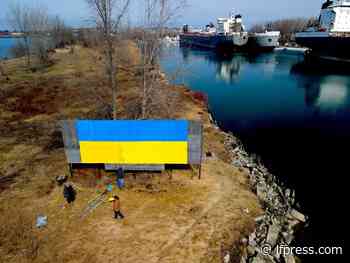Sign of support: Painter transforms blank billboard into Ukrainian flag - The London Free Press