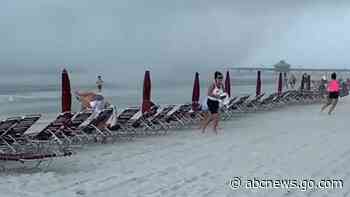 WATCH:  Waterspout sends beachgoers scrambling