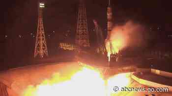 3 cosmonauts arrive at space station in yellow and blue