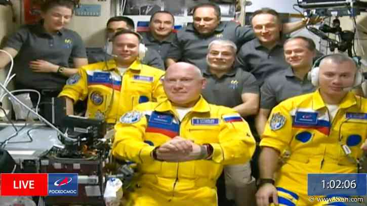 3 Russian cosmonauts arrive at space station wearing Ukraine's colors
