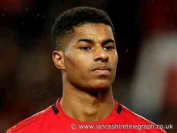 Marcus Rashford shows off the front cover of his new children's book