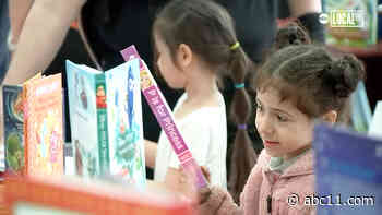 Students line up around the block for Disney's "Magic of Storytelling" 11,000 book giveaway