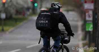 An Uber Eats bicyclist makes a delivery during the coronavirus outbreak, in the U.S. Capitol Hill neighborhood in Washington - Colorado Springs Gazette