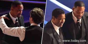 Will Smith appears to wipe away tears as he talks to Bradley Cooper, Denzel Washington at the Oscars