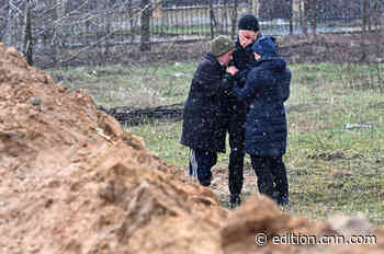 CNN saw at least a dozen bodies piled up in a grave on the grounds of a church in Bucha. The town's mayor says up to 300 people could be buried there.