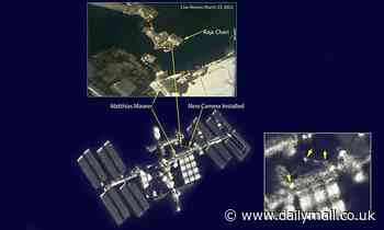 ISS photo taken from the ground shows two astronauts performing a spacewalk