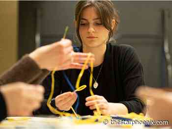 Students weave bracelets in support of Ukrainian refugees