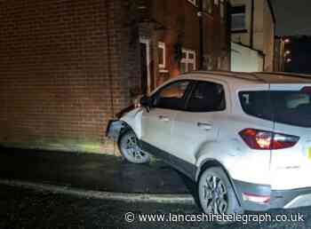 Driver crashes stolen car into house while being chased through East Lancs by police