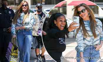 Sofia Vergara looks stylish in a blue tie-dye sweater and jeans before snapping a selfie with a fan - Daily Mail