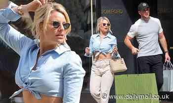 Danielle Armstrong shows off her abs in a cropped shirt as she splashes the cash on designer goods - Daily Mail