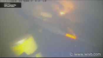 Divers work on repairing hull of USS The Sullivans