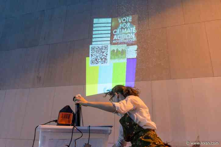 Artist projects Earth Day protest piece onto building next to Texas governor's mansion