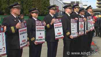 Off-duty Delta pilots picket over schedules causing 'long and fatiguing trips' - KING5.com