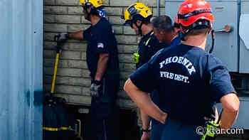 Firefighters in Phoenix use powerful airbag to free man trapped between shipping container, brick wall - KTAR.com