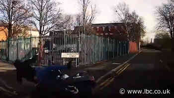 Dash cam shows moment motorcyclist is flung into fence in collision- but who is to blame? - LBC
