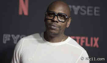 Comedian Dave Chappelle rushed by fan on stage at Netflix show in Los Angeles