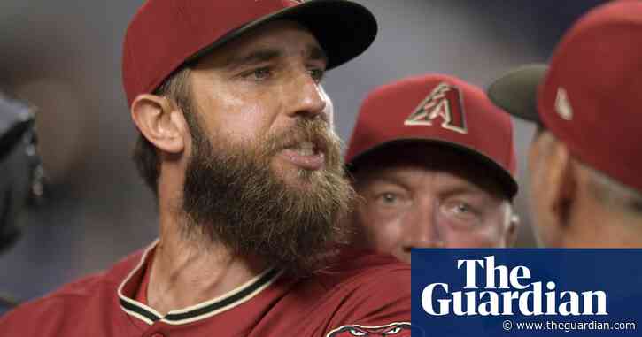 Arizona’s Madison Bumgarner held back by teammates after first-inning ejection