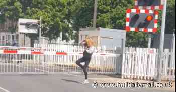 Care-free woman dances in west Hull road while waiting at level crossing - Hull Live