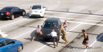 Good Samaritans step into traffic to save driver after vehicle rolls into intersection
