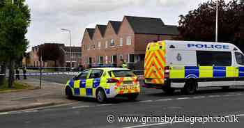 Live updates as man on roof seen throwing tiles at police - Grimsby Live
