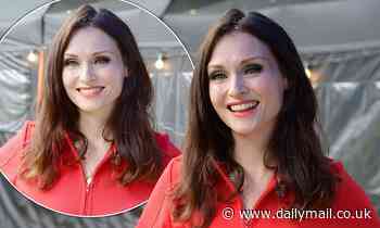 Sophie Ellis-Bextor cuts a glamorous figure in a bright red dress with bold seam detail