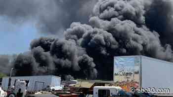 Firefighters battling massive fire at auto facility south of Fresno