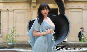 Daisy Lowe puts her ample assets on display in a plunging chic dress as she steps out for dinner