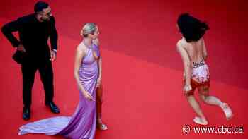 Protester crashes Cannes Film Festival red carpet at George Miller premiere