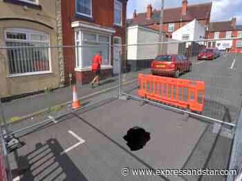 Sinkhole left to grow in middle of residential street for more than two weeks - Express & Star