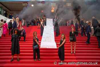 Female activists unfurl banner during Cannes red carpet protest - Ealing Times