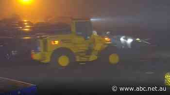 Determined front-end loader thief smashes into police holding yard to 're-steal' a Commodore