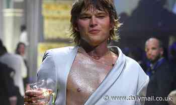 Aussie model Shirtless Jordan Barrett sips champagne on the catwalk at amfAR Cannes Gala