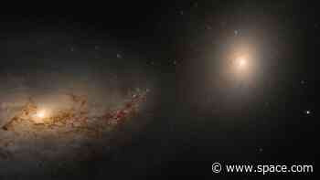 Hubble telescope sees haunting galactic dance of 2 galaxies linked by the corpse of a cannibalized neighbor