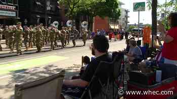 Parade down East Ave features marching bands and messages for veterans