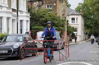 Cyclists wear car frame around bikes in protest of vehicles 'hogging' the roads