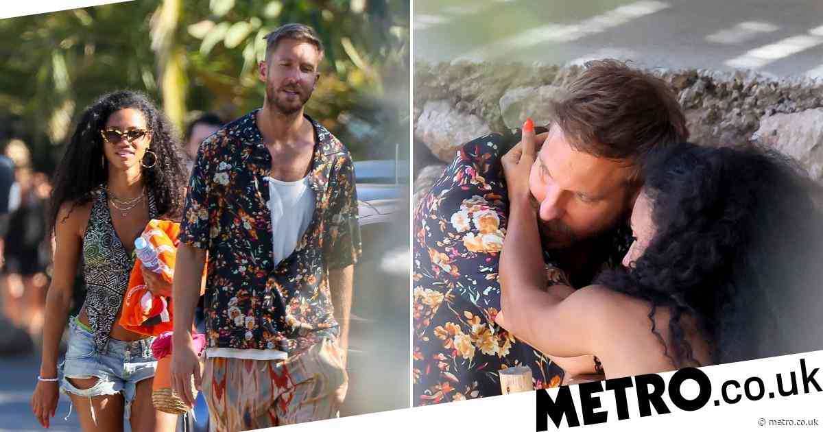 calvin-harris-cosies-up-to-topless-vick-hope-on-the-beach-during