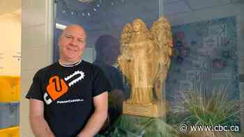 Wooden angel rises from the puddle of an ice sculpture that fell to the pandemic