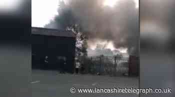 Fire breaks out at Blackburn car garage next to bus depot