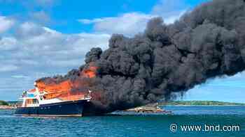 3 people, 2 dogs jump overboard as yacht burns and sinks - Belleville News-Democrat