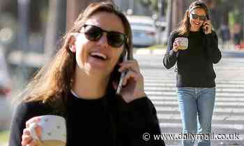Jennifer Garner is seen laughing while on her cell phone as she carries a heart-print ceramic mug - Daily Mail