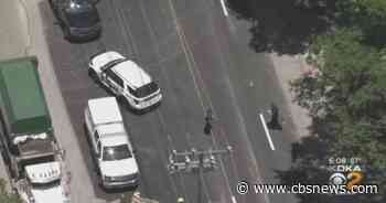 Dump truck hits construction flagger in Forest Hills - CBS News