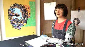 A robot is painting famous faces at Glastonbury festival