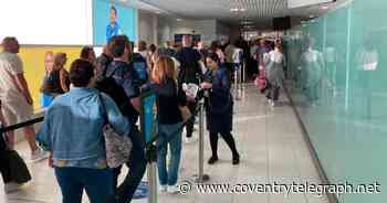 Live - passengers queue at Birmingham Airport but signs things are moving quickly