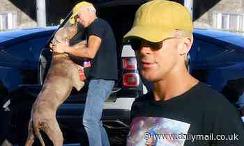 Ryan Gosling gives a quick smooch to his dog on a break from filming Barbie movie