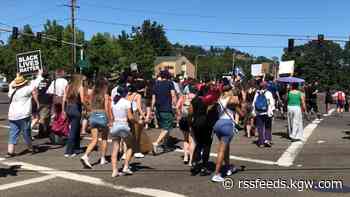 Protesters march in the street after police shoot and kill man in Clackamas County