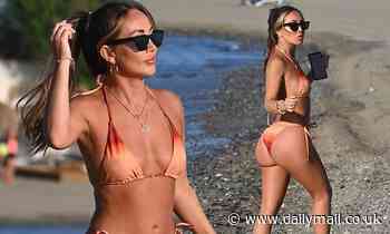 Lauryn Goodman flaunts her toned abs and pert bottom in an ombre string bikini in Marbella