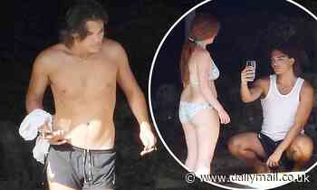 Damian Hurley, 20, is surrounded by female friends as he tops up his tan Liz in Portofino